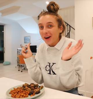 Picture of Emma Chamberlain eating healthy brussel sprouts meal.