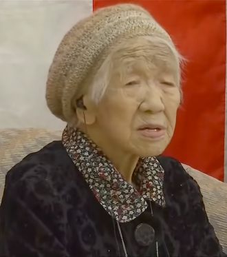 An image of Japan overlayed with a picture of a slim Japanese woman and Kane Tanaka from Fukuoka, Japan who is 116 years old.