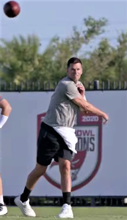 An image of Tom Brady throwing a pass - Bucs Offseason training.
