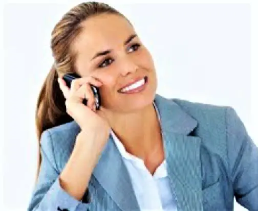 Picture shows a female agent sitting at a desk while talking on the phone