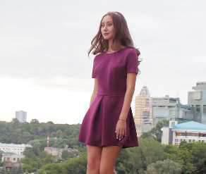 Japanese woman in a purple dress standing and gazing into the distance